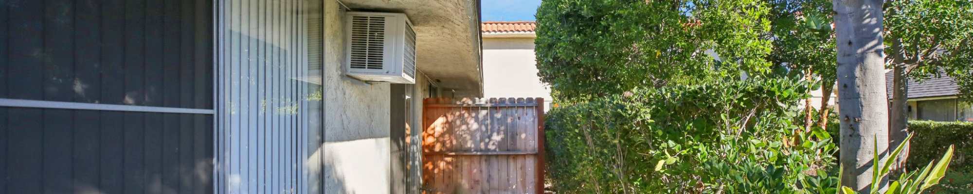 Apartment exterior with lawn at North Pointe Villas in La Habra, California