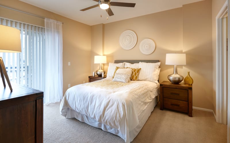 Master bedroom with plush carpeting at Legend Oaks Apartments in Aurora,