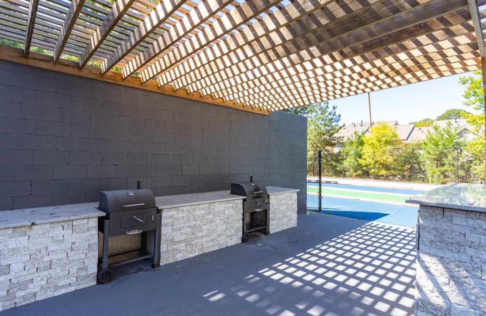 Grilling area by the swimming pool at The Hundred Exchange in Fayetteville, Georgia