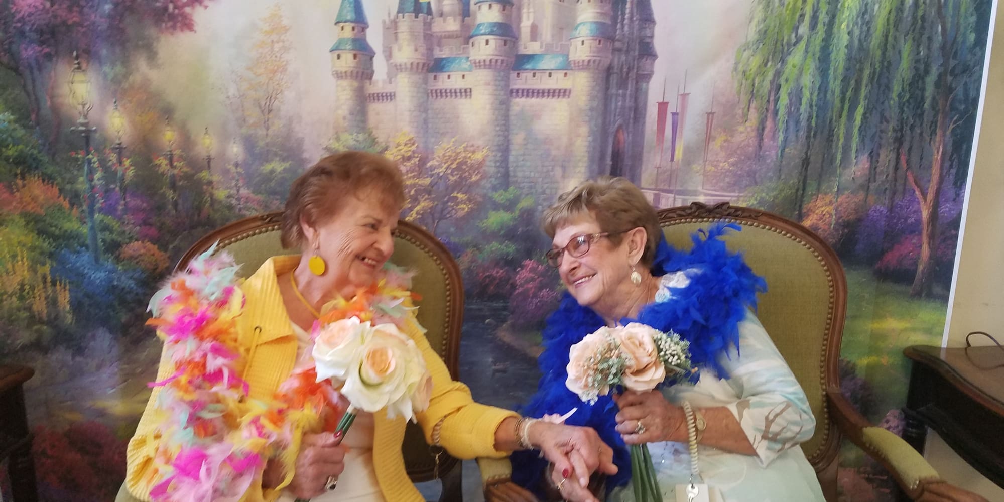 Two happy residents holding hands in front of a backdrop at Salmon Creek in Boise, Idaho