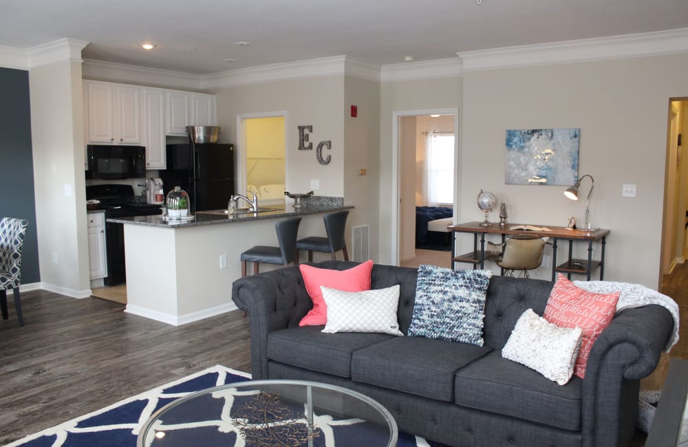 Living room with plank flooring in a model home at Easton Commons Apartments & Townhomes in Columbus, Ohio