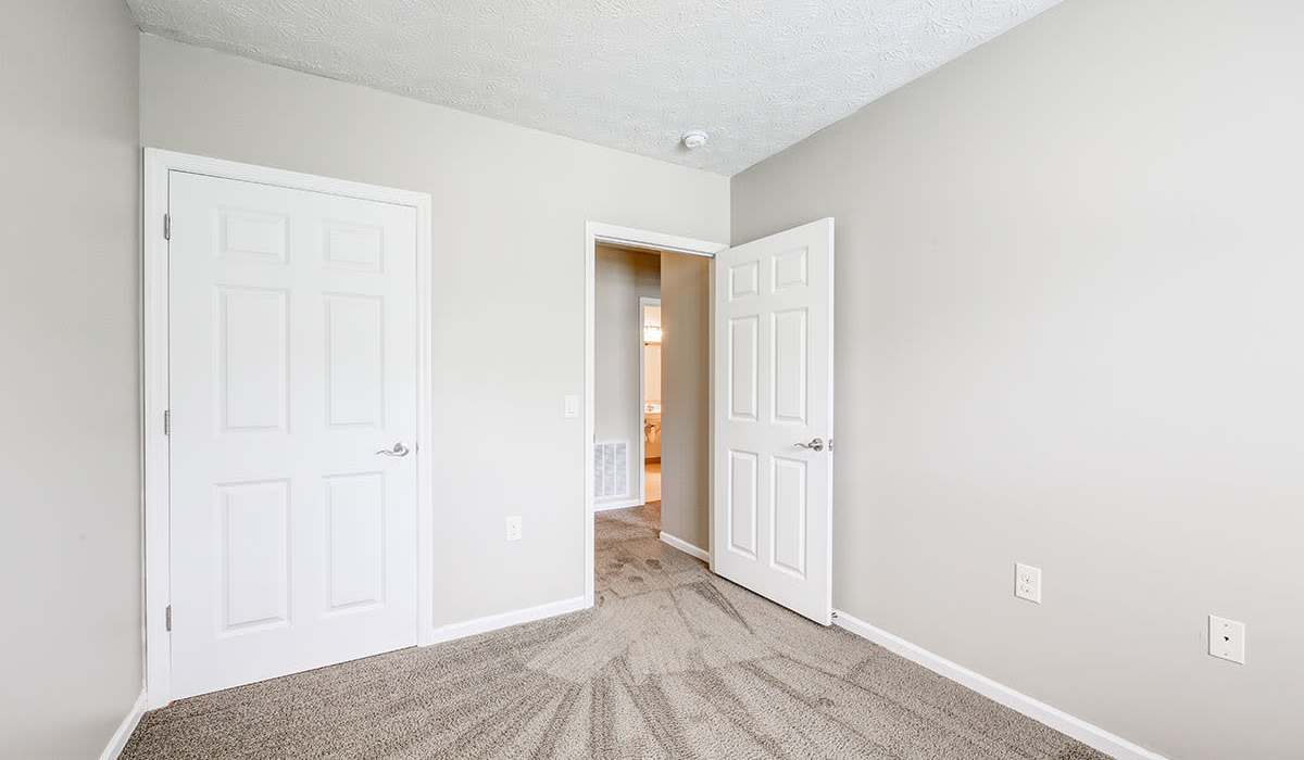 Carpeted room with two white doors at Autumn Run in Millersburg, Ohio