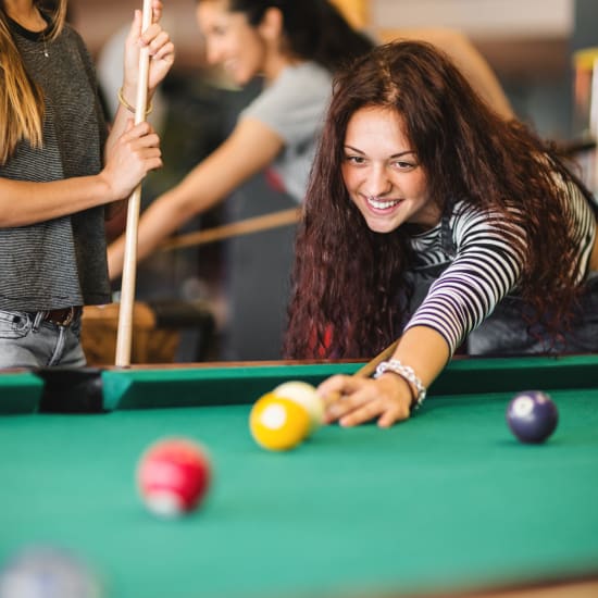 Person playing pool at Bellrock Bishop Arts in Dallas, Texas