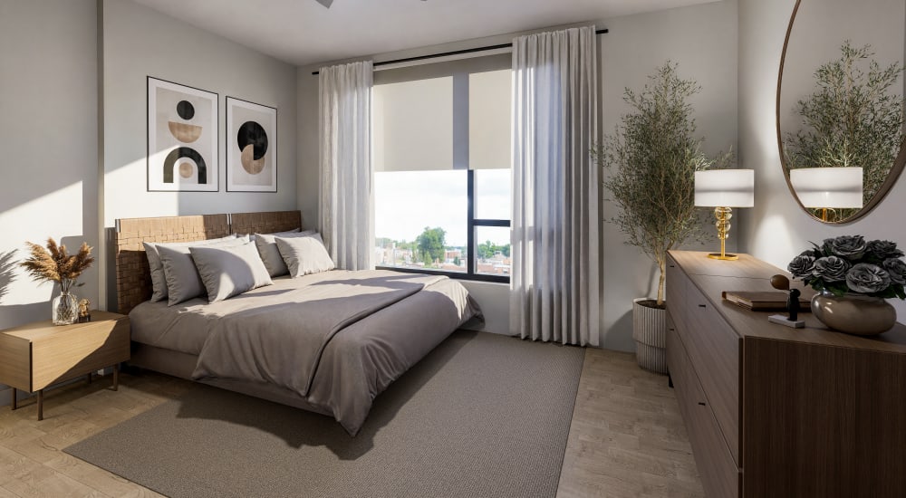 Sunlit bedroom with modern decor and large window view at Bellwood Gateway Apartments in Bellwood, Illinois