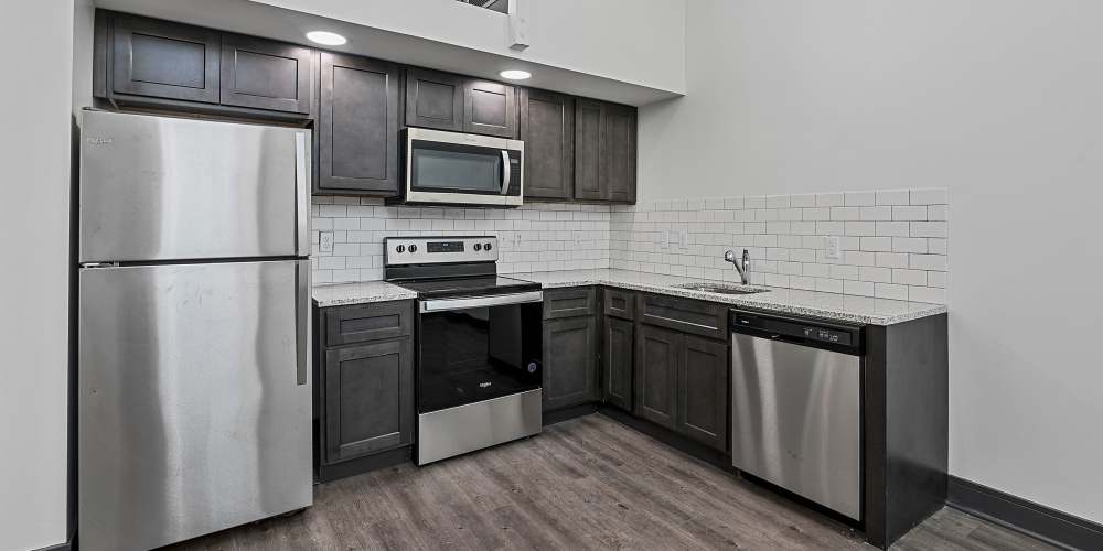 Kitchen with stainless-steel appliances at The Lofts at the Municipal in Lafayette, Louisiana