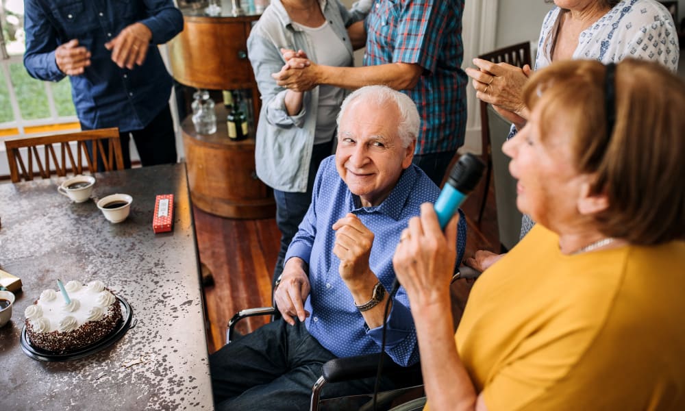 Resident friends having fun at a birthday party for a resident of Mathison Retirement Community in Panama City, Florida. 