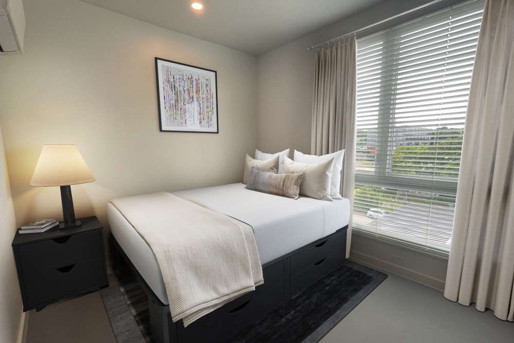 Spacious bedroom with large windows at Martin Flats in Nashville, Tennessee