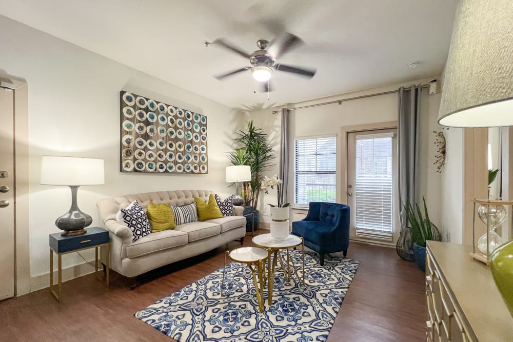 A very large living room with hardwood-style floors at Broadstone Grand Avenue in Pflugerville, Texas