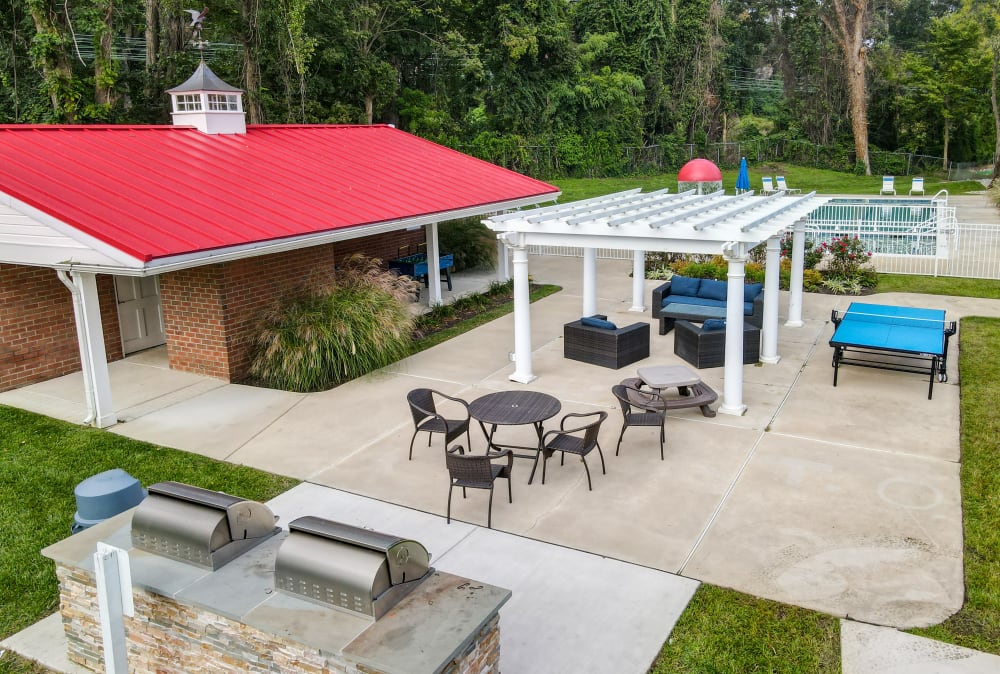 Grilling stations and outdoor lounge area at Strafford Station Apartments in Wayne, Pennsylvania