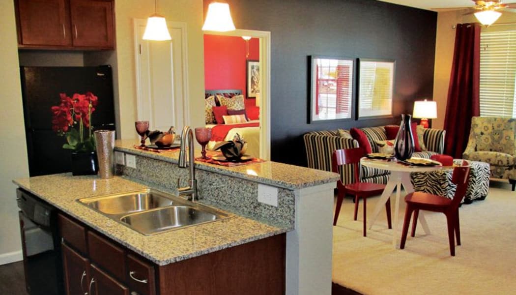 Modern kitchen looking into open-concept living area of model home at Cantare at Indian Lake Village in Hendersonville, Tennessee