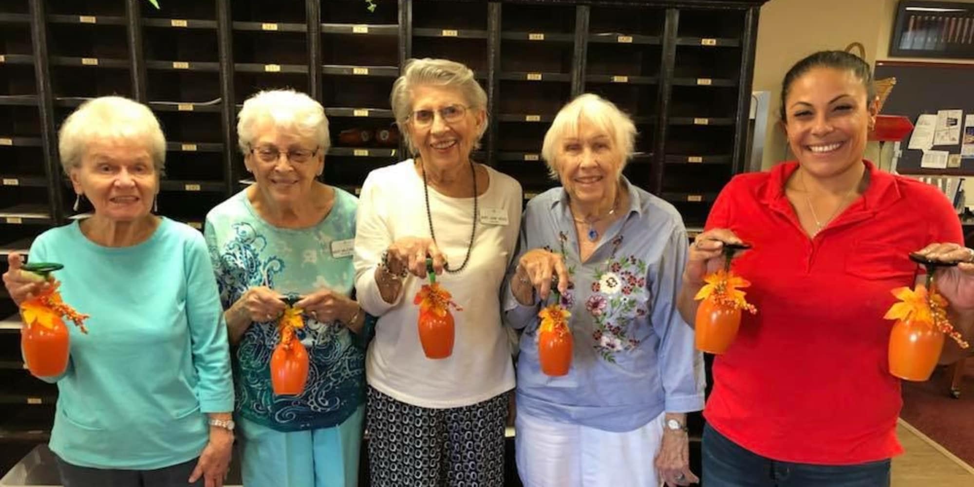 Residents holding decorated cups at Stoneridge Gracious Retirement Living in Cary, North Carolina