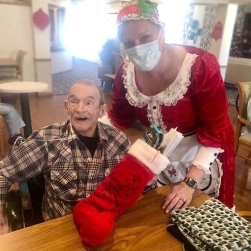 excited resident getting a stocking from a caretaker at Ashbrook Village in Duncan, Oklahoma