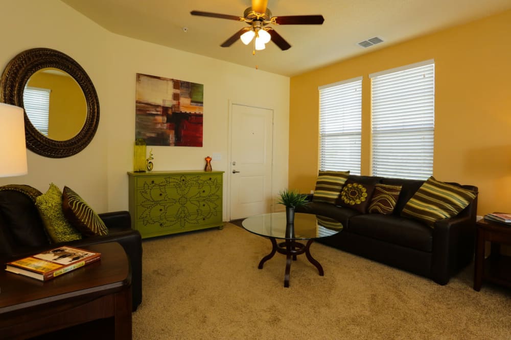 Ceiling fan and plush carpeting in the living area of a model home at The Hawthorne in Jacksonville, Florida