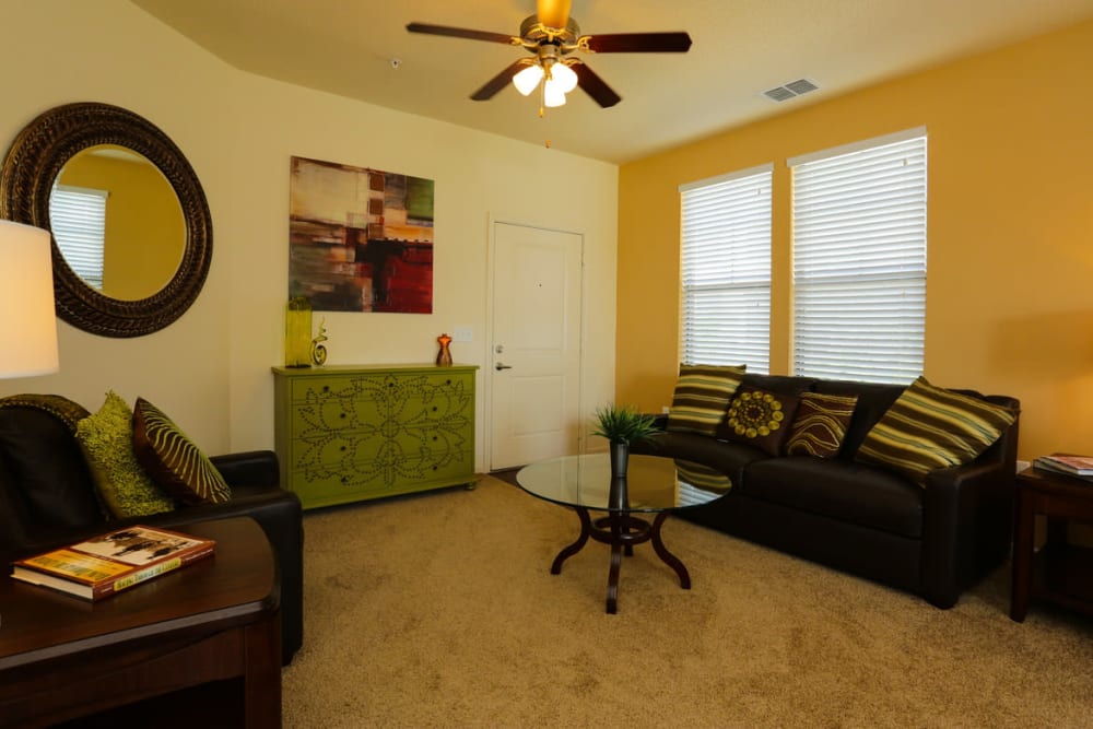 Ceiling fan and plush carpeting in a model home's living area at The Hawthorne in Jacksonville, Florida