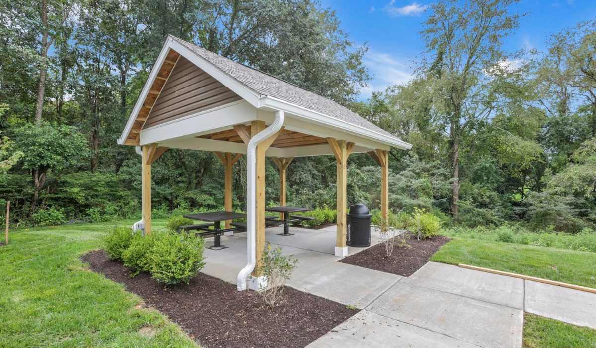 Covered pavilion with picnic tables and trash can at The Lofts On First in The Plains, Ohio