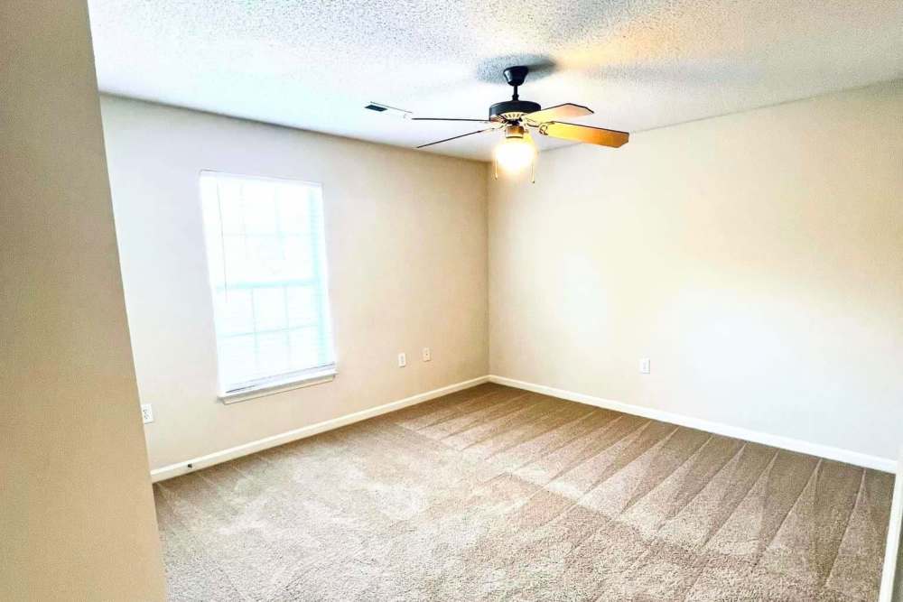 Bedroom with a ceiling fan and windows at Lodge at Lakeshore in Greensboro, North Carolina