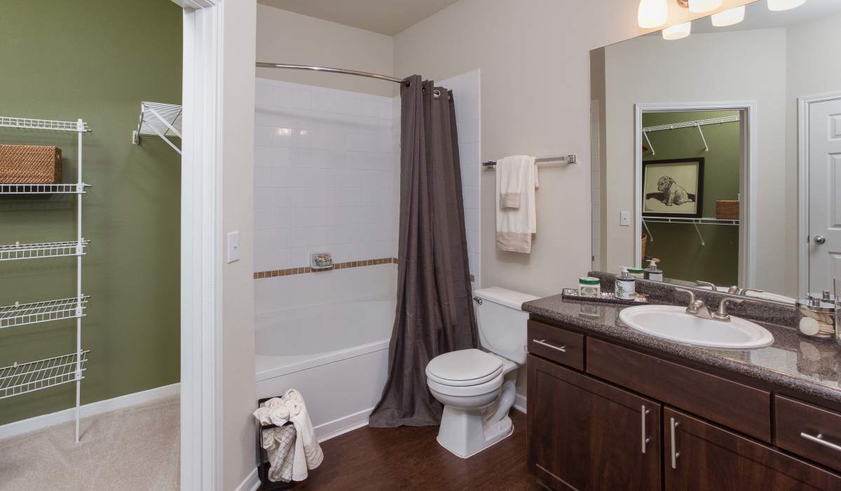 Bathroom with commode and bath tub at Whispering Pines Ranch in The Woodlands, Texas