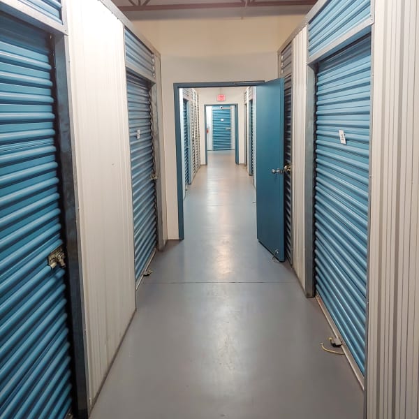 Indoor storage units with blue doors at StorQuest Express Self Service Storage in Tampa, Florida