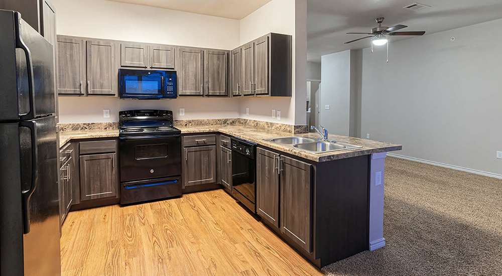 Gourmet kitchen with updated appliances at Sunset Lodge in Odessa, Texas              