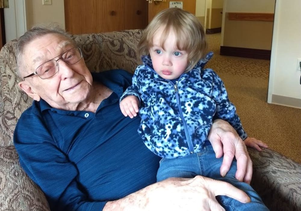 Resident with grandchild at Bell Tower Residence Assisted Living in Merrill, Wisconsin