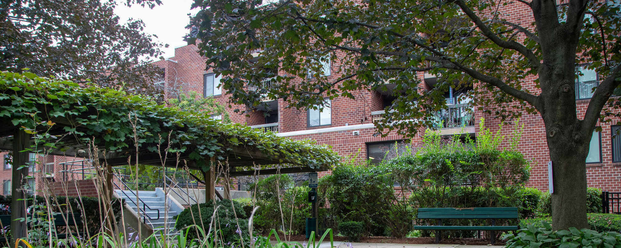 Landscaped courtyard with seating area at Victory Gardens in East Boston, Massachusetts