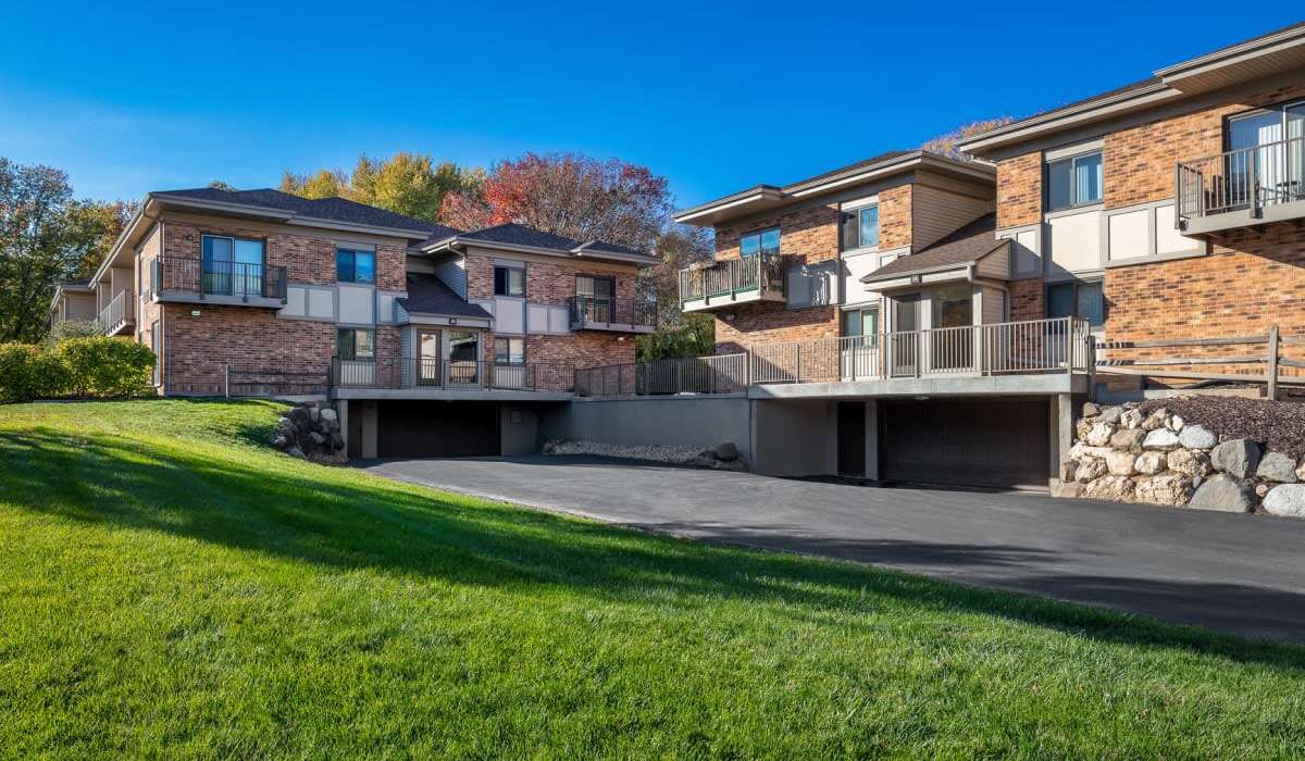 Beautiful exterior view of the community with lush green grass and trees at Schroeder Square Apartments in Madison, Wisconsin