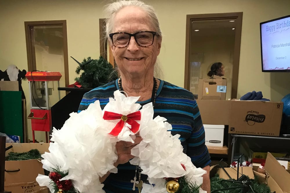 Resident showing her wreath at Edencrest at Riverwoods in Des Moines, Iowa