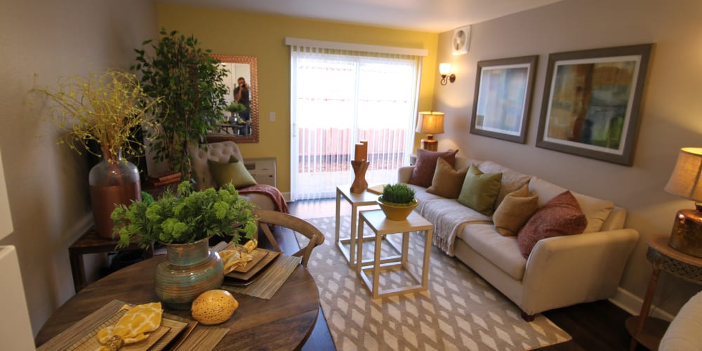 Living room of a model apartment home opening onto a private balcony at Ramblewood Apartments in Fremont, California