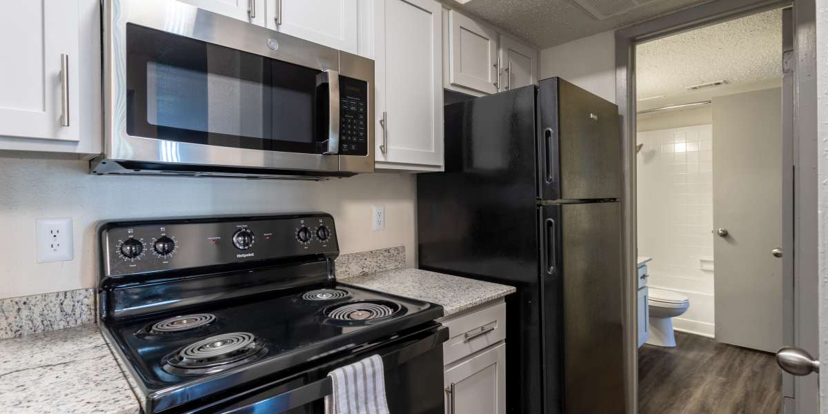 Kitchen with all black appliances at The Bentley Apartments in Dallas, Texas