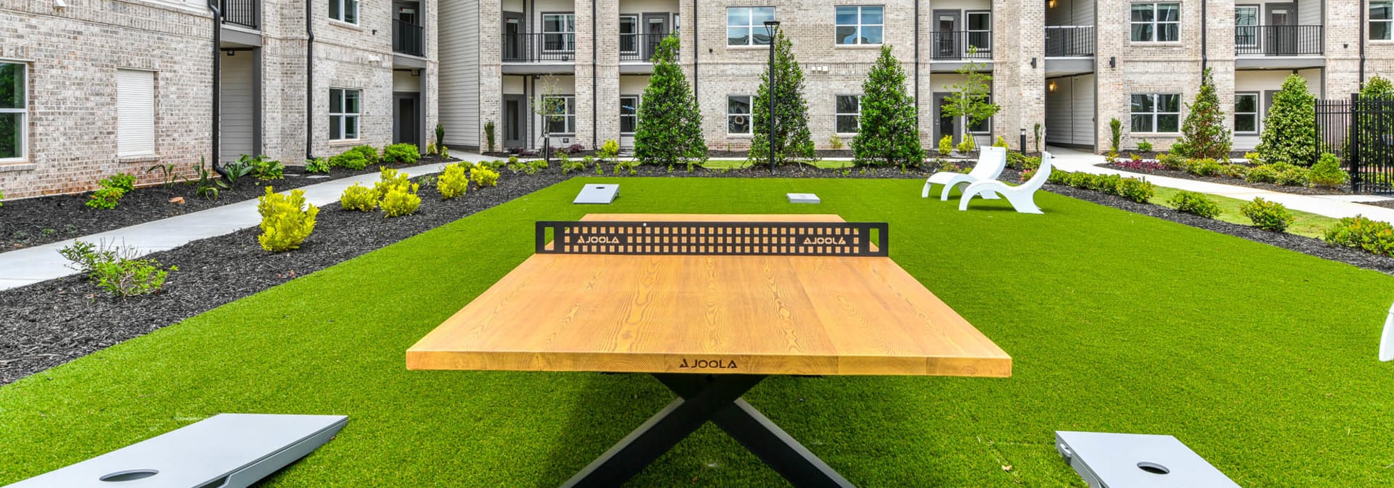 Courtyard with ping pong table and cornhole boards at Somerset in McDonough, Georgia