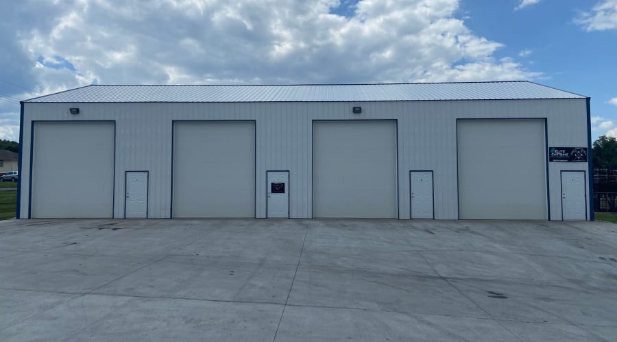 A family carrying storage boxes into their new home near KO Storage in Sedalia, Missouri