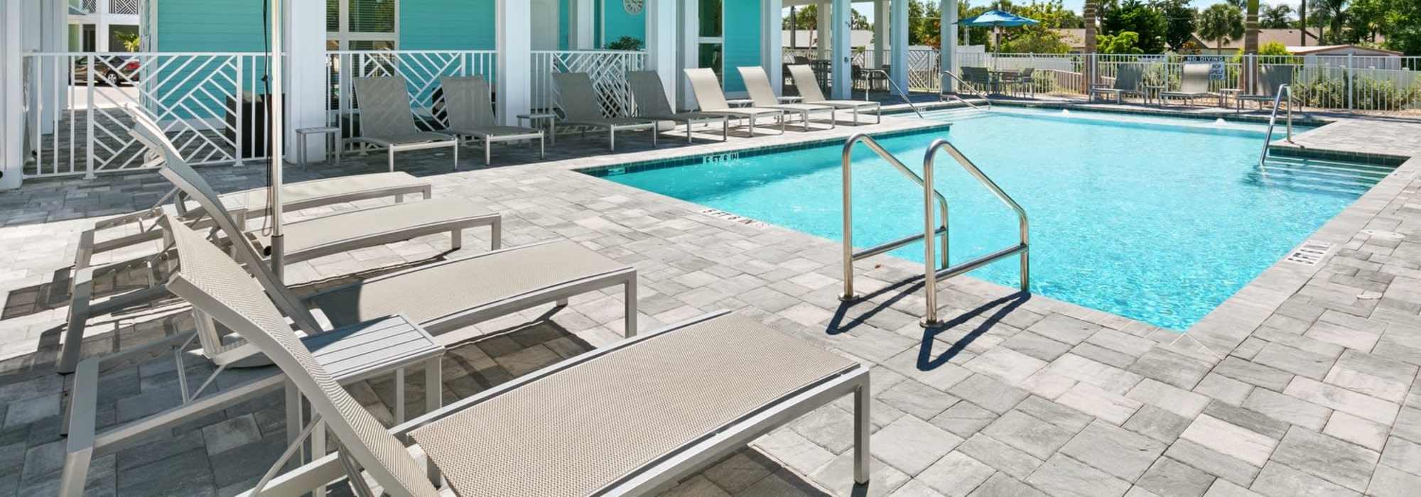 Relaxing retreat with a sparkling water pool and inviting lounge area at Lemon Bay Apartments in Englewood, Florida.