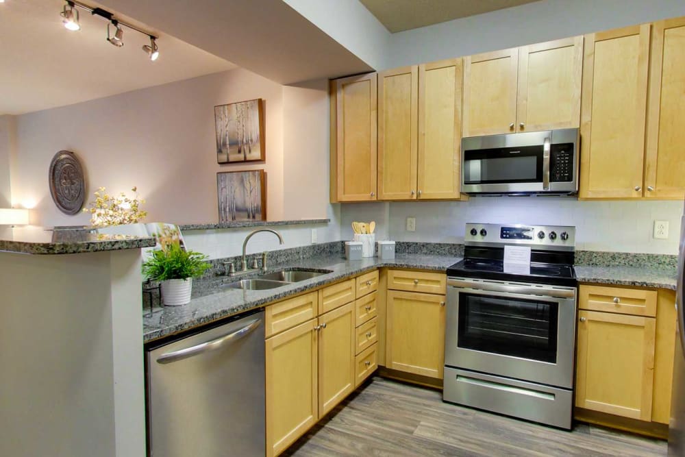 Kitchen with stainless steel appliances and granite countertops at SouthPark Morrison in Charlotte, North Carolina