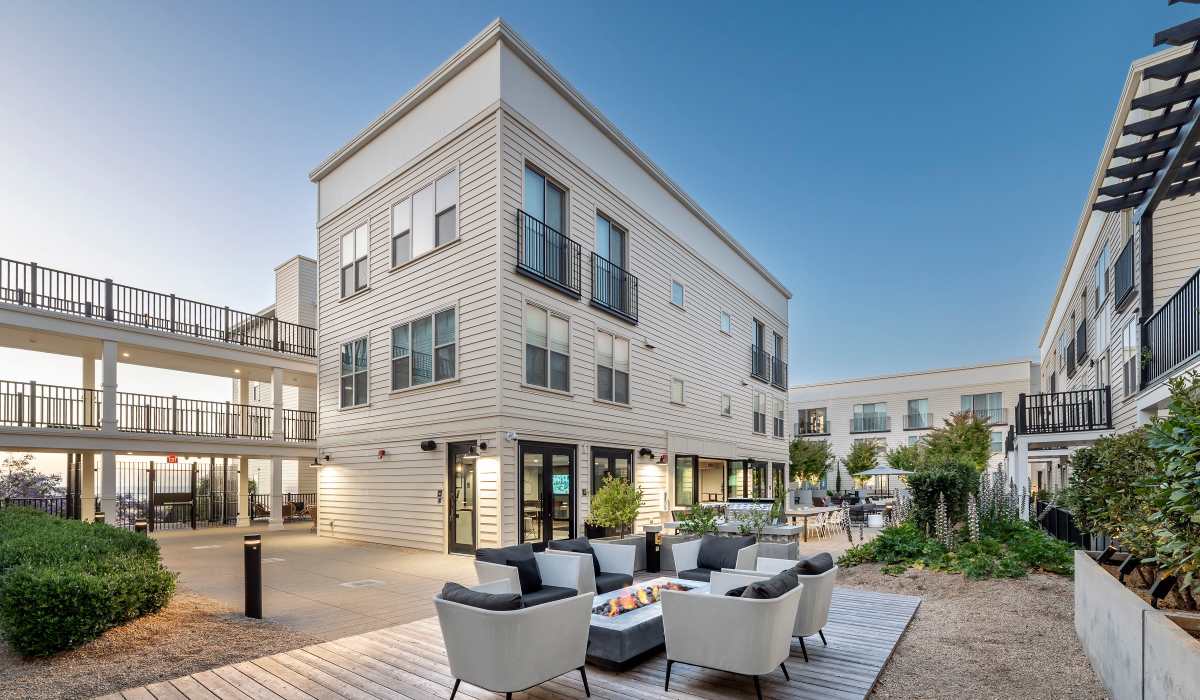 Courtyard seating surrounded by plants at The Dylan Apartment Homes in Hercules, California