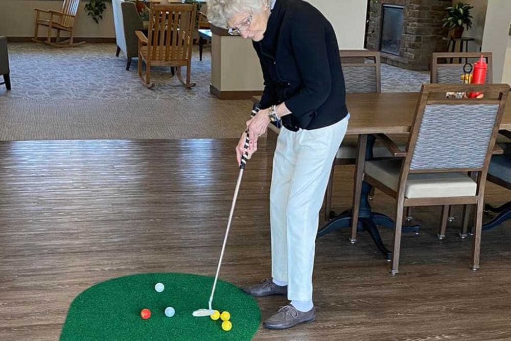 Residents gather for mini golf at Country Meadow Place in Mason City, Iowa