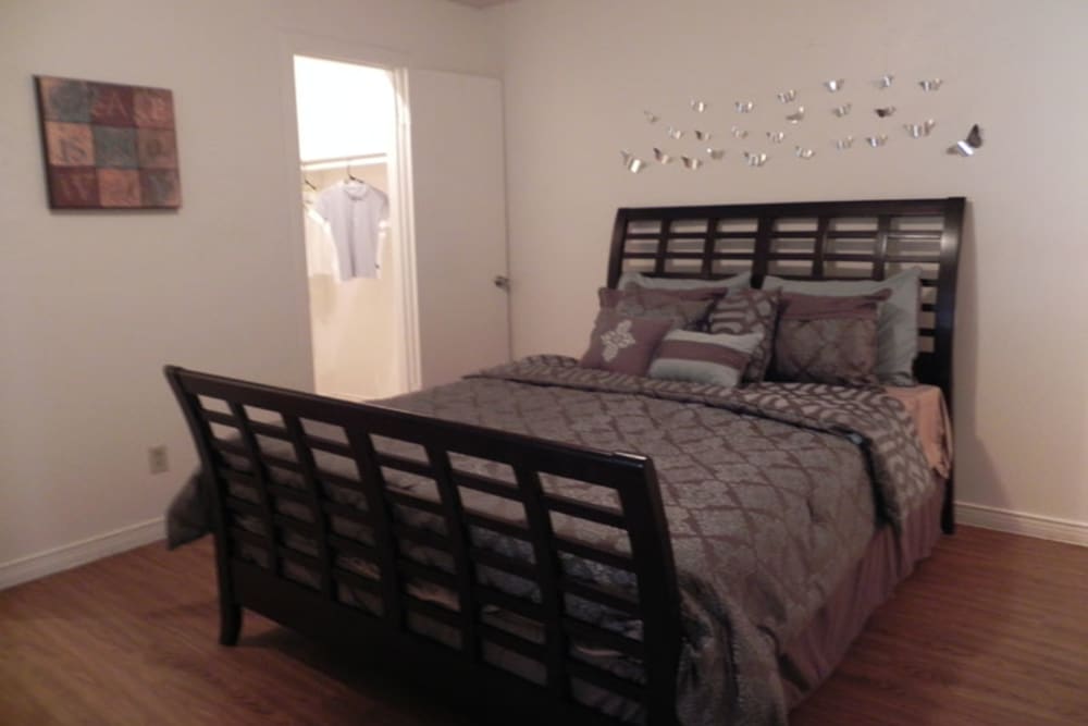 Model bedroom with walk-in closet at Woodland Park in Arlington, Texas