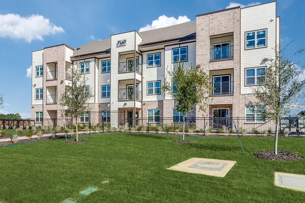 Exterior view with well maintained lawn at The Trail Lakes in Fort Worth, Texas