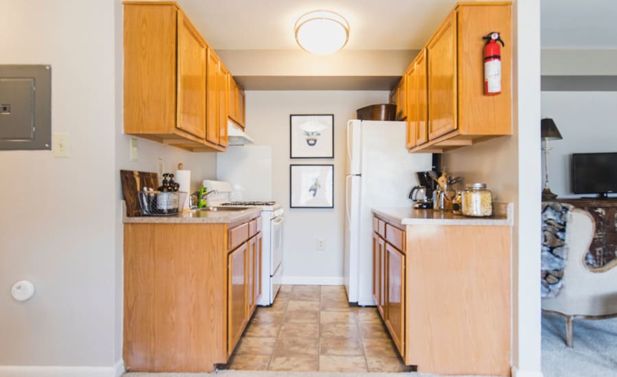 Wood cabinetry and granite countertops in model home's kitchen at Westgate Apartments & Townhomes in Manassas, Virginia