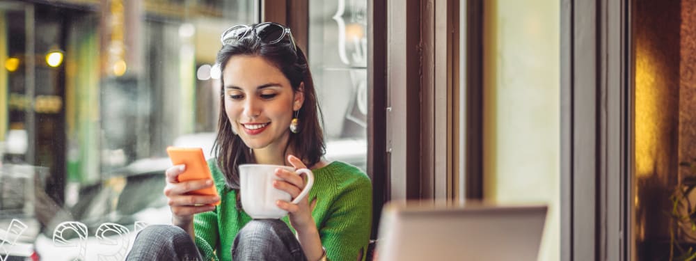 Woman drinking coffee at coffee shop at Haven Hills in Vancouver, Washington