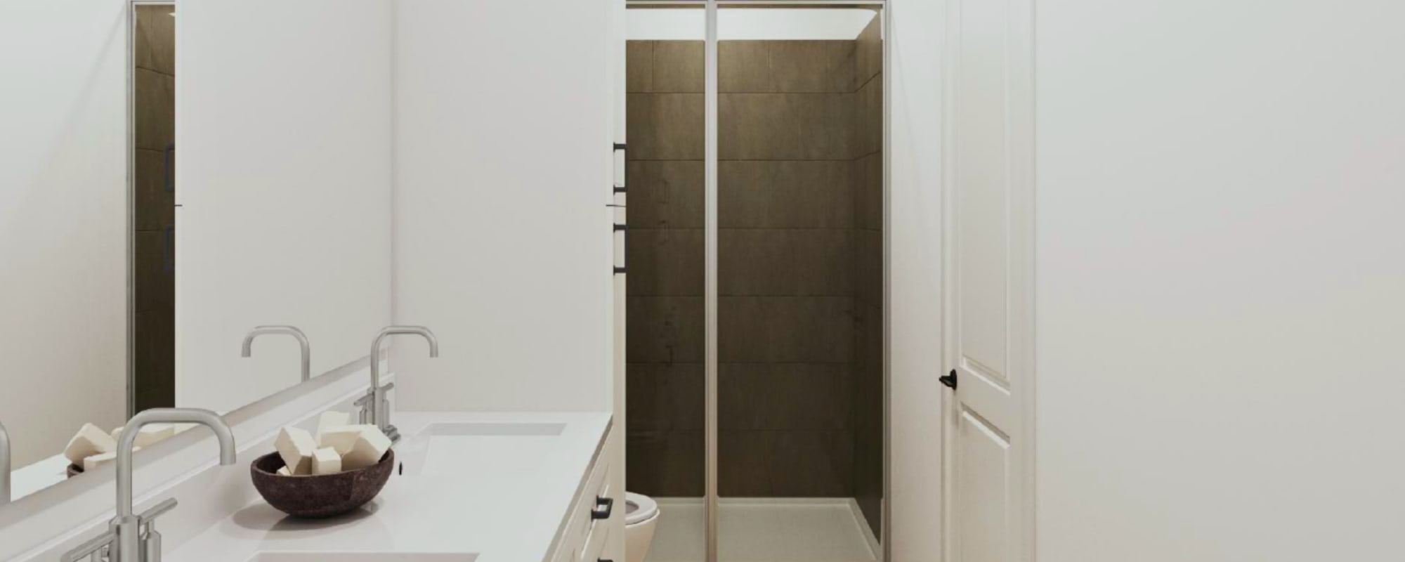 Modern bathroom with mirror, sink and shower at Two West End in Charlotte, North Carolina