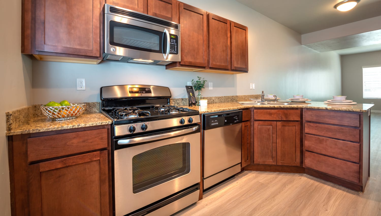 Kitchen with stainless steel appliances at Olympus at the District in South Jordan, Utah