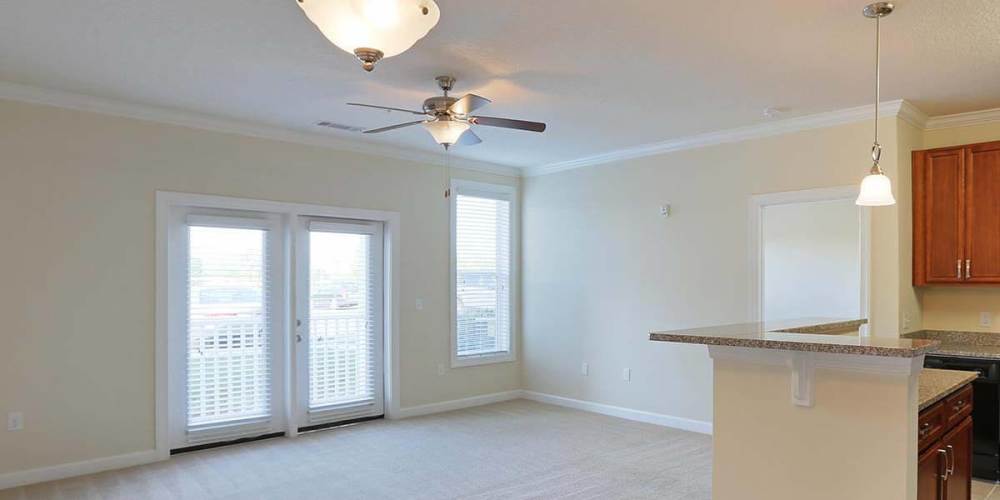 Unfurnished living room with connecting kitchen at Seasons at Poplar Tent in Concord, North Carolina