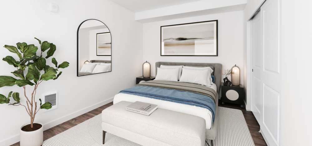 A comfy bed in a bedroom of an apartment home at Allegro in Lynnwood, Washington 