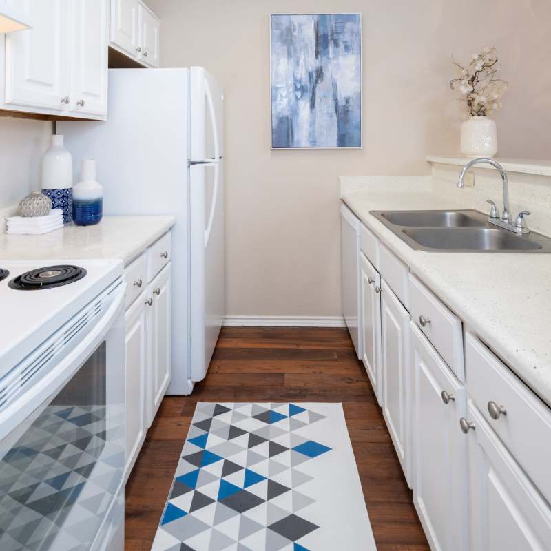 Charming kitchen with modern white cabinetry and sleek countertops at Charter Oak in Euless, Texas.
