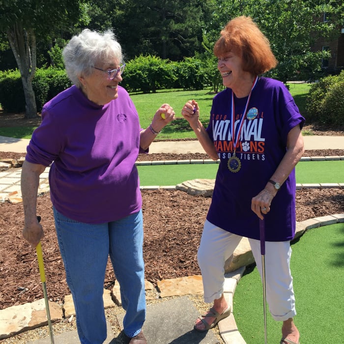 Residents playing mini golf near The Clinton Presbyterian Community in Clinton, South Carolina