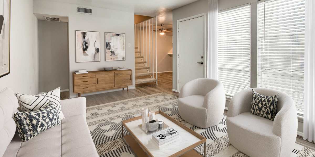Living room with couch and carpet at Tribecca Pointe Apartments in Hurst, Texas
