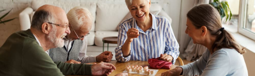 Residents playing a board game and laughing together