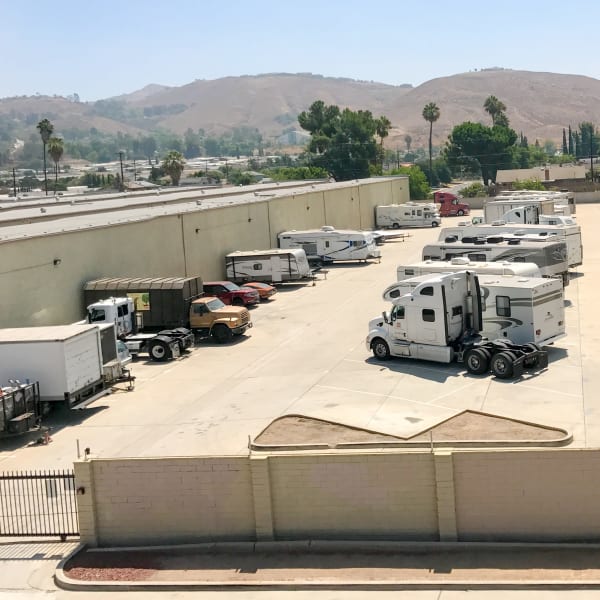 RVs, boats, cars, and trailers parked at StorQuest Self Storage in Riverside, California