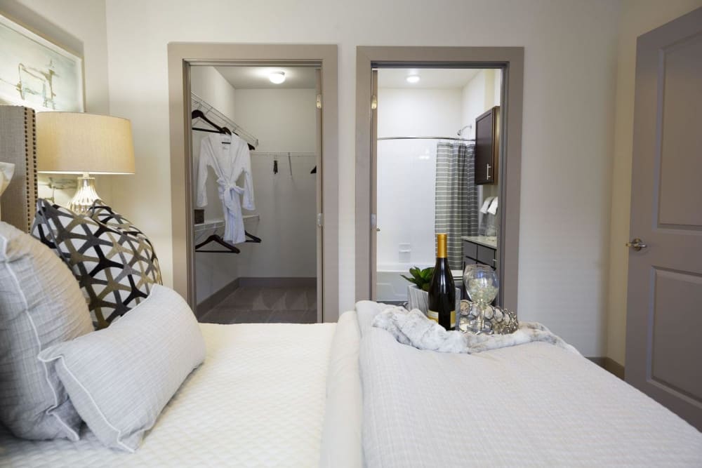 Expansive walk-in closet and ensuite bathroom in a model bedroom at Steelyard in Oklahoma City, Oklahoma