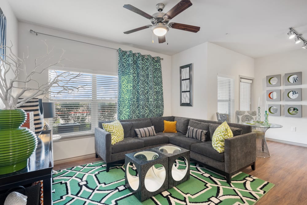Model living room with hardwood style flooring at The BLVD in San Angelo, Texas